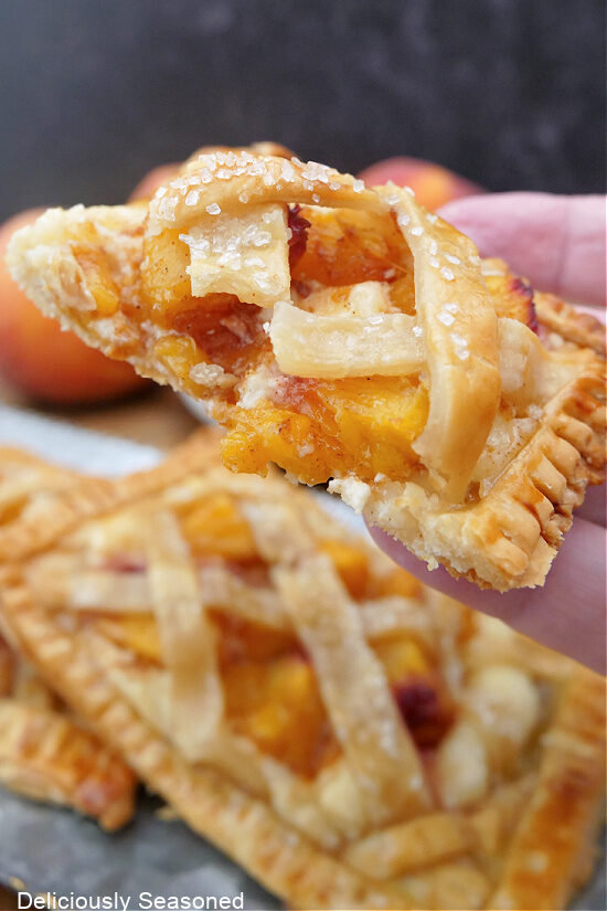 A peach pastry square cut in half showing the filling.