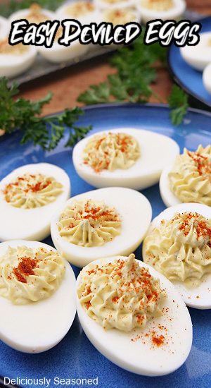 A round blue plate with deviled eggs on it.