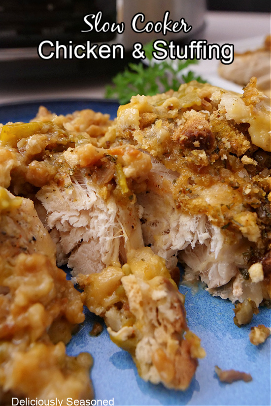 Chicken topped with stuffing on a blue plate.