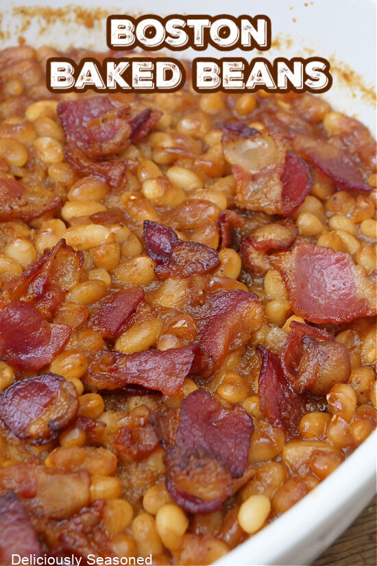 A close up of a white baking dish with Boston Baked Beans in it.