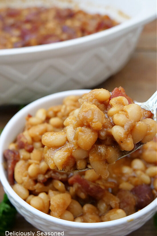 A small white bowl filled with baked beans.