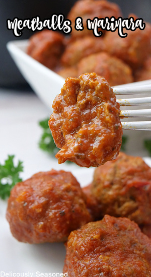 A meatball on a fork with a bite taken out of it with more meatballs on a plate and in a bowl.