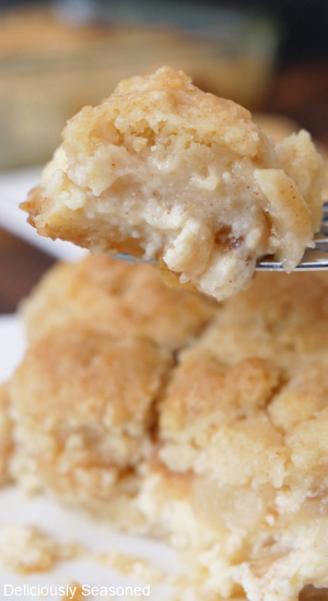 A close up of a bite of pear cobbler on a fork.