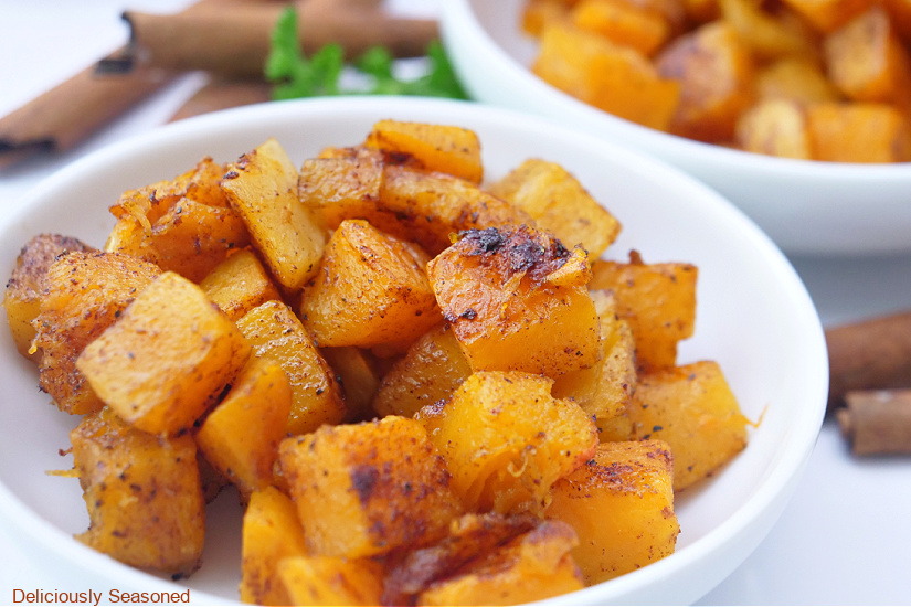 A horizontal photo of a white bowl with butternut squash in it.