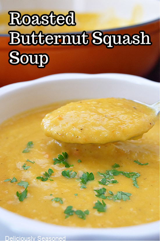 A title picture of butternut squash soup with a spoonful of soup being held out of the bowl.
