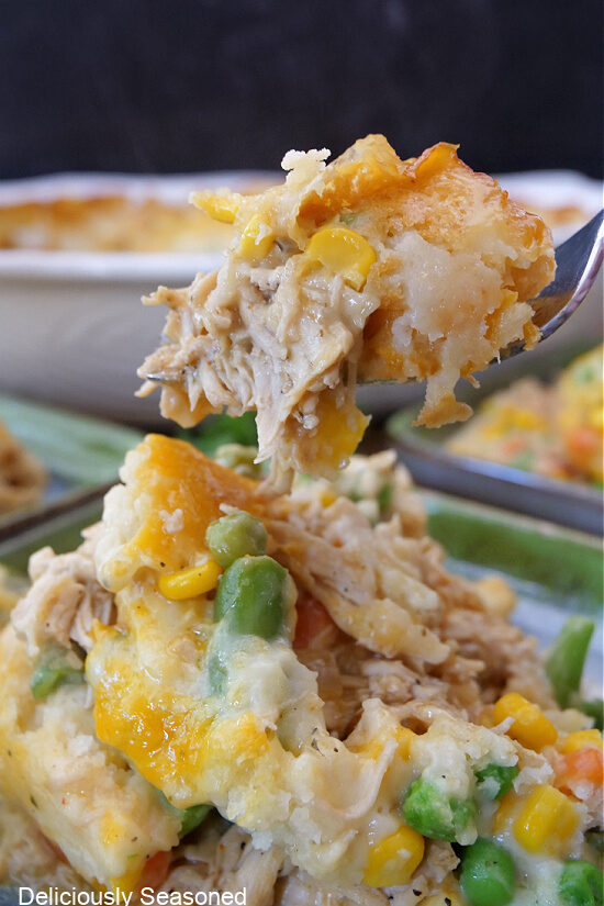 A close up of a spoonful of chicken cobbler casserole.