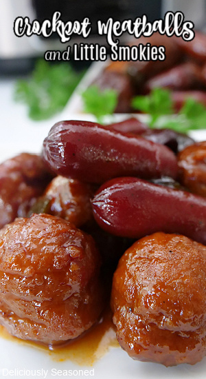 A close up photo of meatballs and lit'l smokies on a white plate.