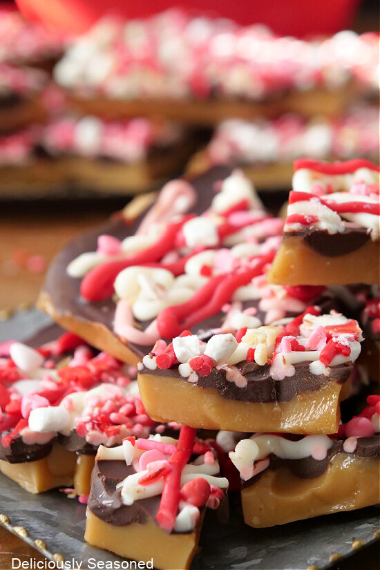 A close up of pieces of Valentine Crack candy toffee on a silver tray.