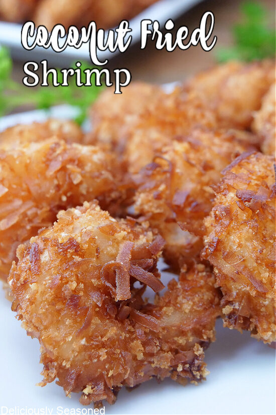 A white plate with a close of view of coconut shrimp.