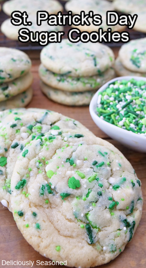 Sugar cookies on a wood surface with Saint Patrick's Day sprinkles on them.