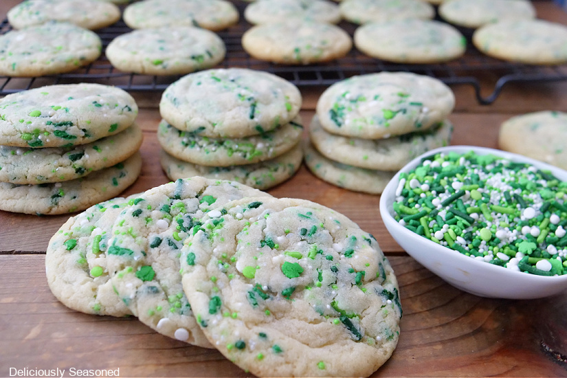 A horizontal photo of St. Patrick's Day sugar cookies stack up on it.