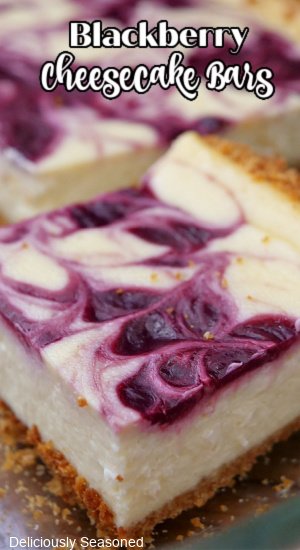 A close up of a sliced cheesecake bar with the title of the recipe at the top of the photo.
