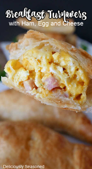 A breakfast turnover with a big bite taken out of it. 