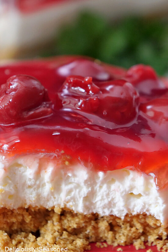 A close up picture of a slice of cherry dessert.