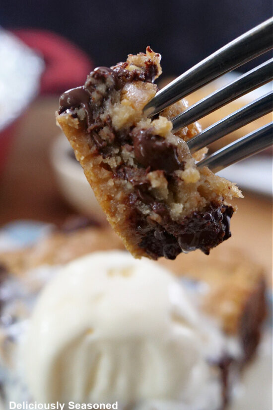 A bite of chocolate chip cookie pie on a fork.