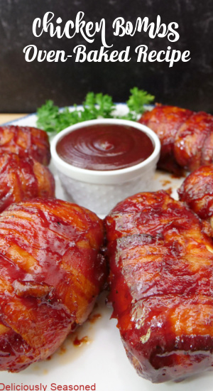 A white plate with six bacon wrapped chicken bombs on it and the title of the recipe at the top of the photo.