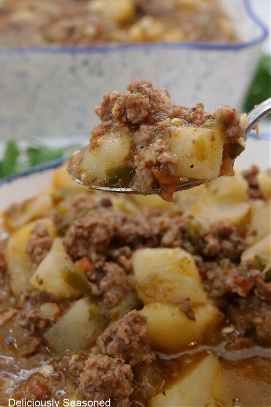 A close up of a spoonful of Mexican picadillo.