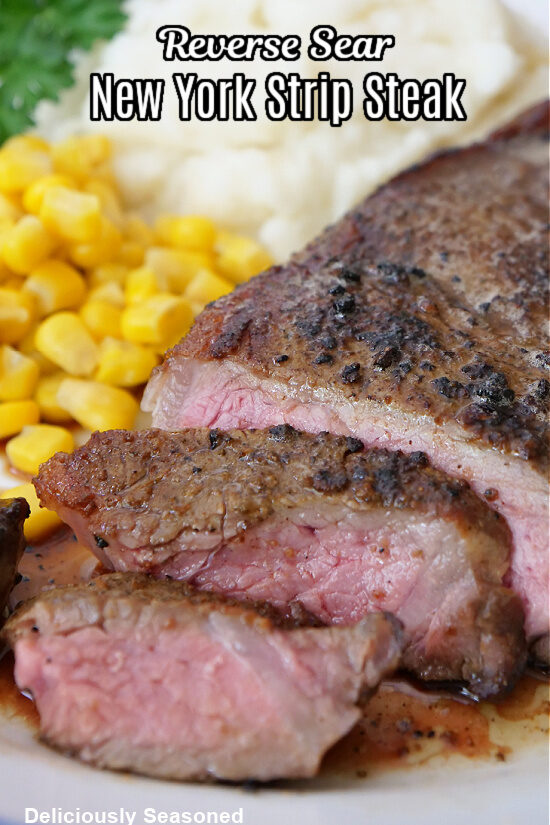 A white plate with a steak that has been sliced with corn and mashed potatoes.