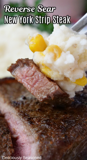 A close up of a fork with a bite of steak and mashed potatoes on it with the title of the recipe at the top of the photo.