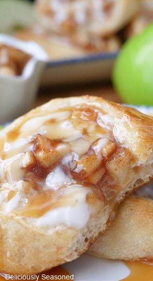 A close up of a apple pizza roll with a bite taken out of it.