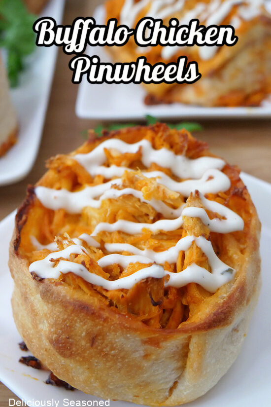A small white plate with a buffalo chicken pinwheel on it.