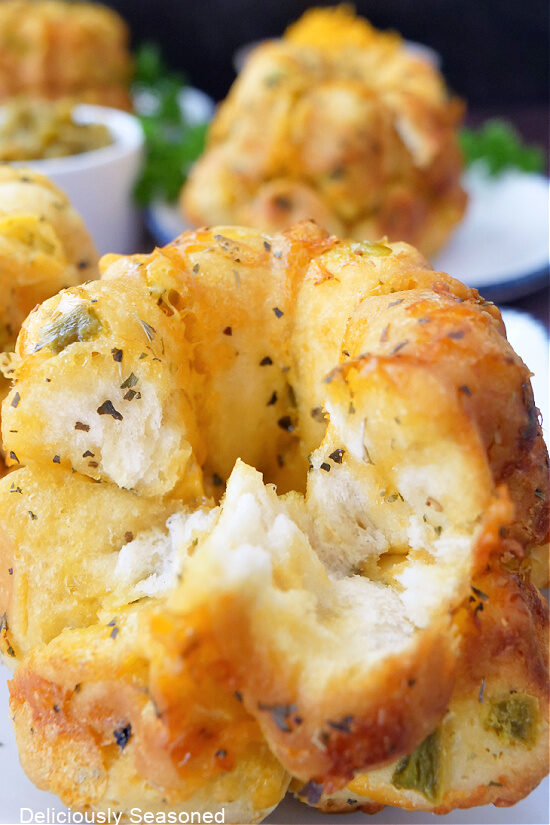A jalapeno cheese monkey bread with a few pieces removed.