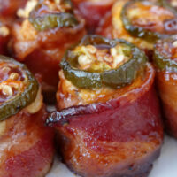 A close up of a few bacon wrapped appetizers.