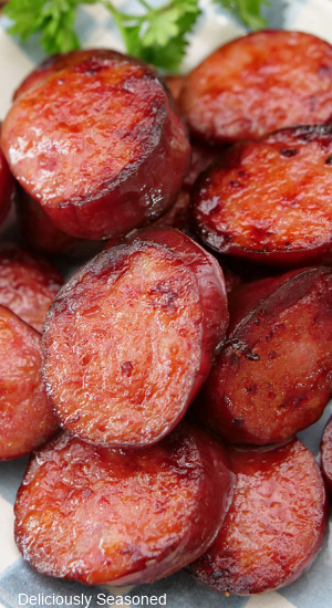 A close up photo of a plate of sliced smoked sausage.
