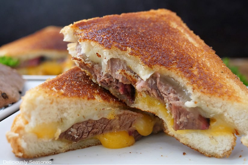 A horizontal photo of a grilled cheese filled with leftover brisket and two types of cheese.