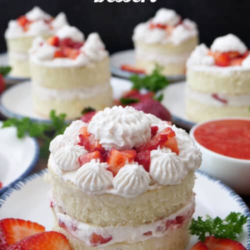 White plates with blue trim with individual strawberry shortcakes on them.