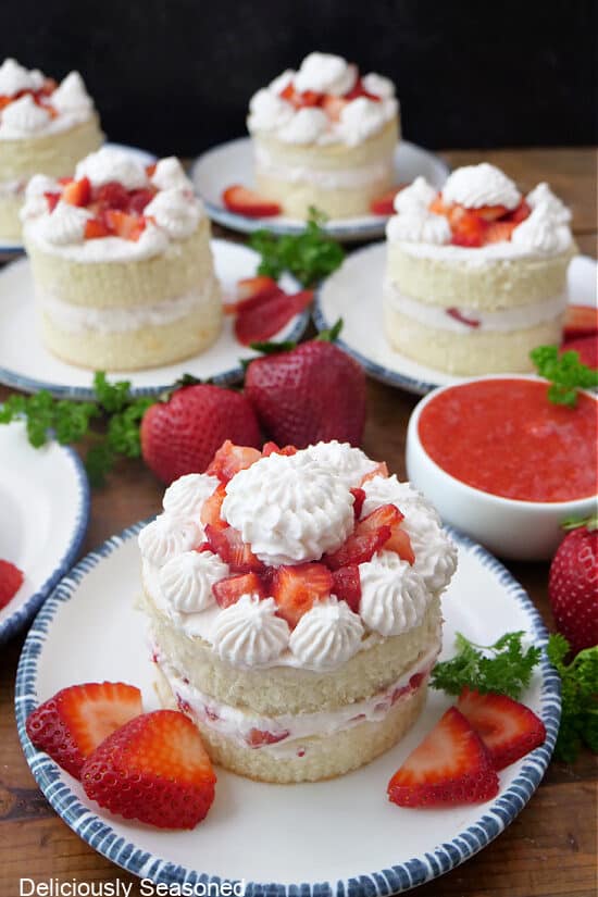 Five individual two tier shortcakes with strawberries and homemade whipped cream.