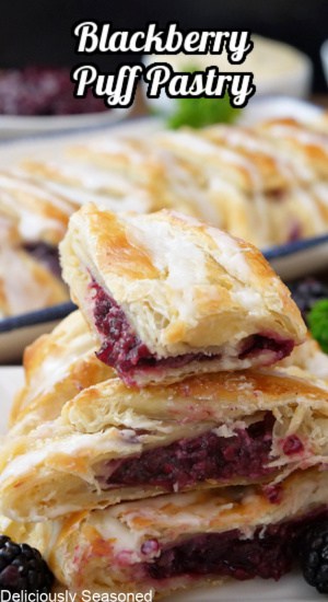 A small stack of blackberry pastries on top of each other showing the fruit filling.