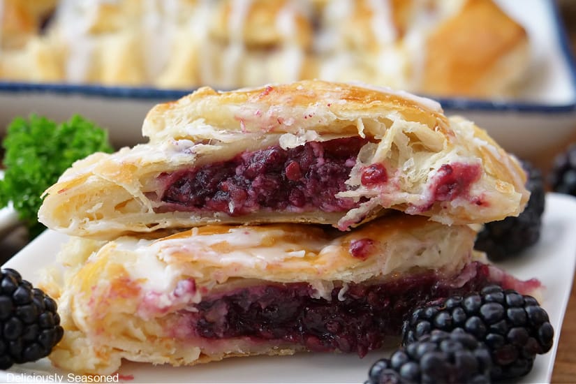 A horizontal photo of two servings of puff pastry placed on top of each other showing the fruit filling.