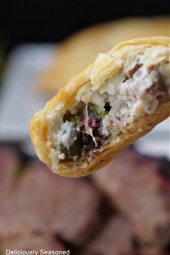 A close up of an empanada with a bite taken out of it.