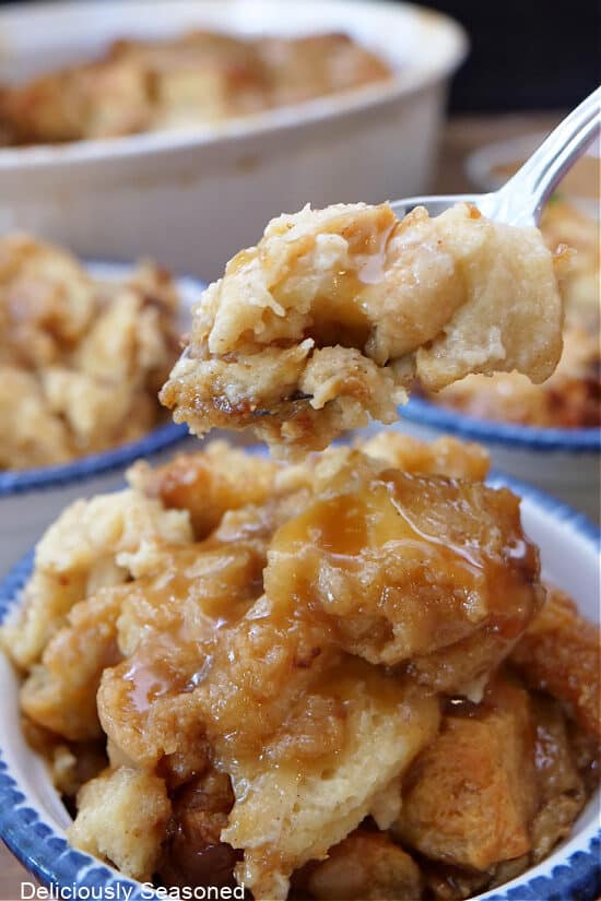 A close up of a spoonful of bread pudding.