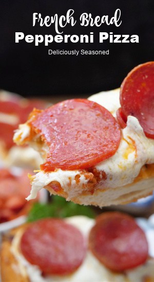 A slice of pizza bread with thick pepperoni slices on it.
