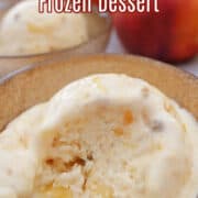 A bowl with a scoop of peach cobbler frozen dessert in it.