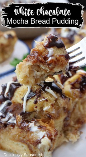 A bite of bread pudding on a fork with a serving of it on a white plate, and the title of the recipe at the top of the photo.