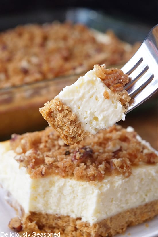 A bite of maple cheesecake bar on a fork.