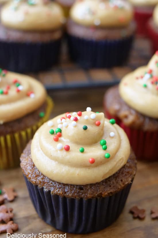 A bite-size mini cupcake with frosting and candy sprinkles on top.