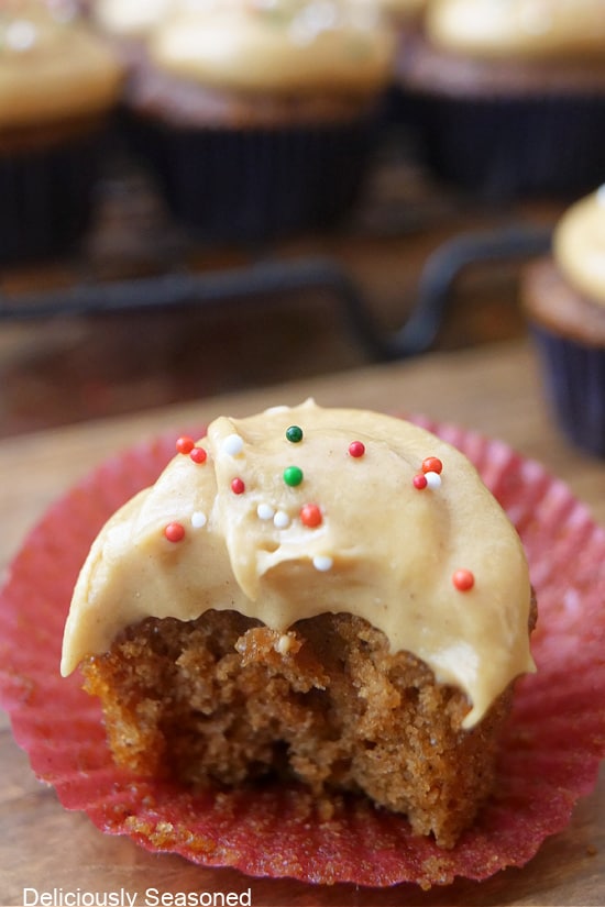 A mini gingerbread cupcake with a bite taken out of it.