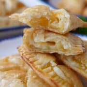 A close up of nectarine hand pies stacked on top of each other.