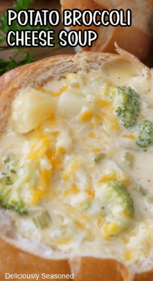 A bread bowl filled with potato broccoli cheese soup.