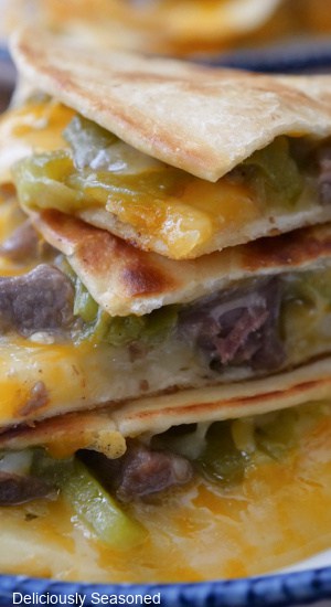 A close up of steak and cheese quesadillas on a plate.