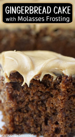 A close up of a slice of gingerbread cake with frosting.