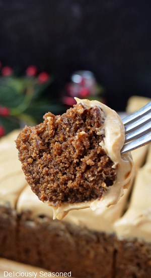 A bite of gingerbread cake on a fork.