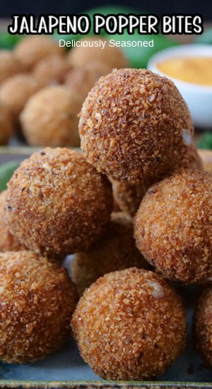 A close up of a stack of deep fried jalapeno popper bites.