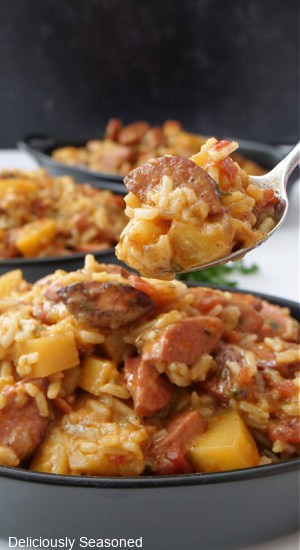 A spoonful of sausage, rice and potatoes.