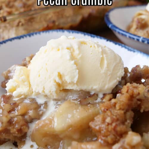 A white bowl filled with a serving of caramel apple crumble with a scoop of vanilla ice cream on top.