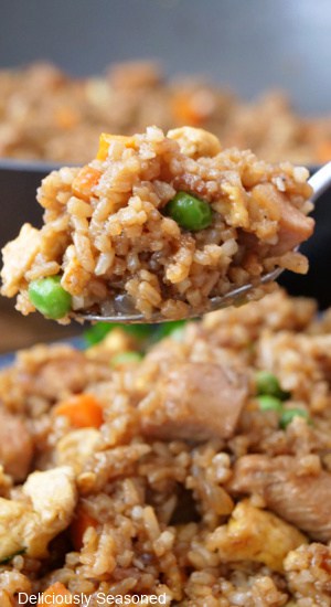 A close up of a spoonful of fried rice.